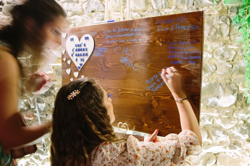 In questa foto un'invitata al matrimonio di Elisa e Francesco lascia un messaggio sul Guest Book