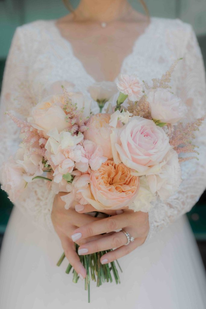 In questa immagine un mazzo di fiori con rose, astilbe e peonie. 